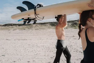Two people with surfboard on the head in France on the Atlantic coast