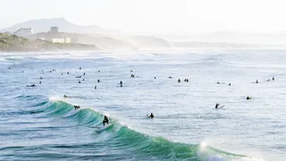 Waves in Biarritz with surfers at a France Atlantic Coast Camping Trip